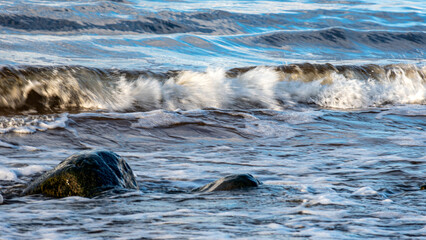 beautiful waves crashing against the seashore, windy day on the rocky shore of Vidzeme, Baltic Sea