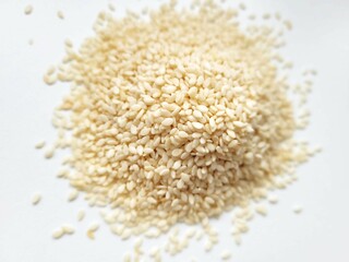 Pile of white sesame on a bright background.