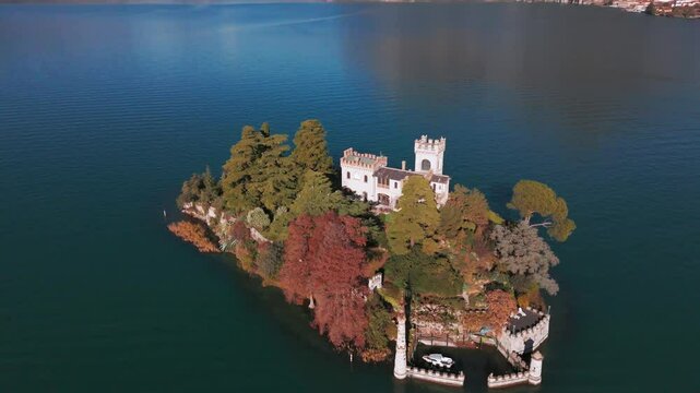 Aerial view of Isola di Loreto, small island in Iseo Lake, Italy surrounded by mountains