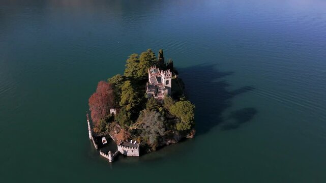 Aerial view of Isola di Loreto, small island in Iseo Lake, Italy surrounded by mountains