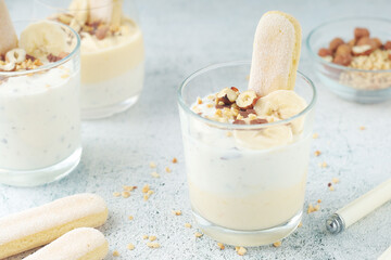 Milk mousse dessert with nuts in glasses