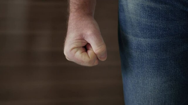 Shooting with an Angry Man Clenching the Fist in Sign of Protest. One Person Getting Mad and Clench the Hand Fingers in a Fist.