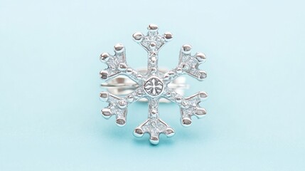 A delicate silver brooch in the shape of a snowflake, set against a frosty blue background