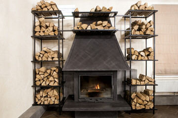 Stylish interior element with a fireplace and shelves for firewood. Interior of a fireplace area for a bar, cafe, restaurant in a modern style.