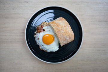 A plate of bacon and egg sandwich.