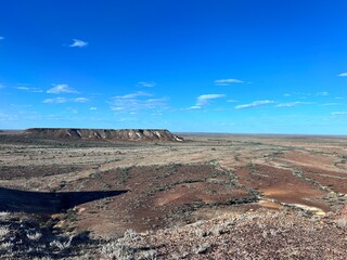 Kanku Breakaways Conservation Park, near Coober Pedy, features striking desert landscapes with colorful cliffs, vast plains, unique geological formations, and rich Aboriginal heritage.