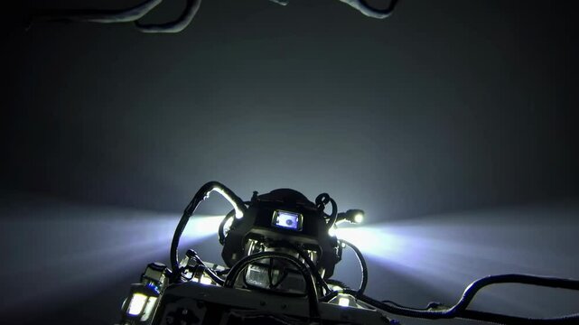 Underwater drone exploring the deep sea is encountering a terrifying creature with tentacles and sharp teeth, creating a dramatic and suspenseful scene in the dark depths of the ocean