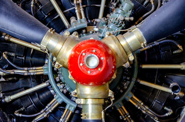 detail of old airplane engine with propeller. Close up of a red plane propeller. Damaged jet engine on large aircraft. World War II era heavy bomber engine and propeller closeup. High quality photo