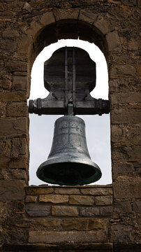 An old bell at the top of an old church.
