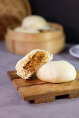 A piece of food is cut in half and placed on a wooden cutting board