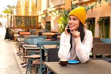 Modern lifestyle. Beautiful woman multitasking with coffee and a smartphone in hand. Copy space