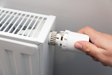 Person is adjusting the temperature on a radiator