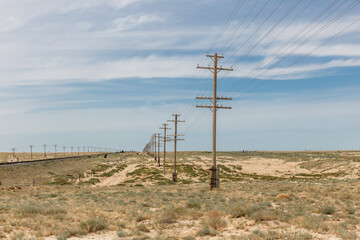 Electric and communication lines alongside railway in Mangystau Region, Kazakhstan