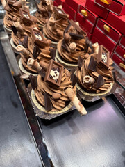 Chocolate cupcake with wafer rolls at bakery showcase