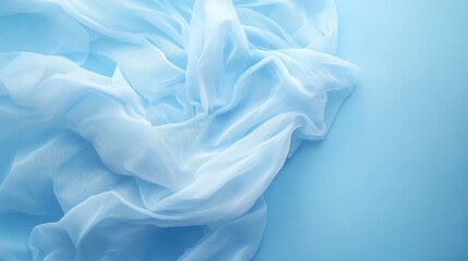 Obraz premium Flowing chiffon skirt placed on a pale blue background, creating a calming and serene aesthetic.
