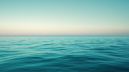 Obraz premium Calm turquoise ocean with a gradient sky at dawn creating a serene seascape view