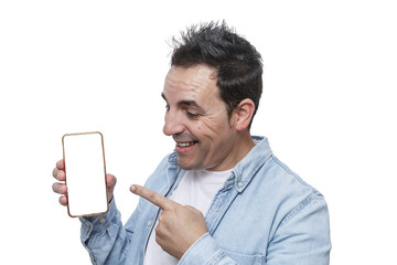 Man smiles while pointing at a blank smartphone screen in a bright setting, showcasing excitement and engagement