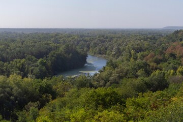 Obraz premium Beautiful view of the river from the top of the hill. Landscape with a river and a steep bank on an autumn morning.