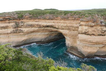 Loch Ard Gorge, situated along the Great Ocean Road in Victoria, is a stunning natural wonder featuring dramatic limestone cliffs, clear blue waters, and a historical shipwreck site, with walking trai