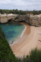 Loch Ard Gorge, situated along the Great Ocean Road in Victoria, is a stunning natural wonder featuring dramatic limestone cliffs, clear blue waters, and a historical shipwreck site, with walking trai