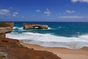 London Bridge, along the Great Ocean Road, is a natural rock formation that once resembled a bridge. It collapsed in 1990, leaving two rock pillars, creating a unique coastal landmark.