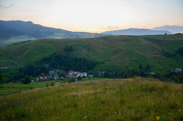 Idyllic rural setting with green fields and a distant village