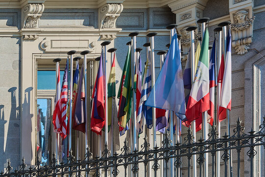 International flags flying over historic building