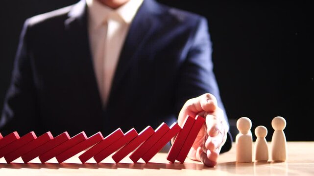 Concept of Risk Assessment, Crisis, Economic, Business Management, Inflation. Hand of businessman stopping, prevent falling block, domino effect to safe family life, property, insurance from crisis.