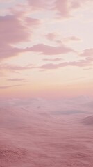Obraz premium A serene landscape featuring soft pink hues and gentle clouds at sunset.