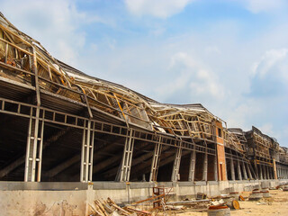Burnt warehouse with deformed columns and fire damage captured in wide-angle perspective.