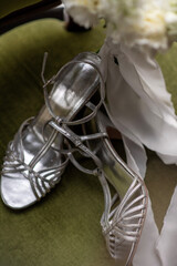 Silver bridal heels and floral bouquet close up