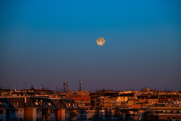 Full moon on morning, city skyline