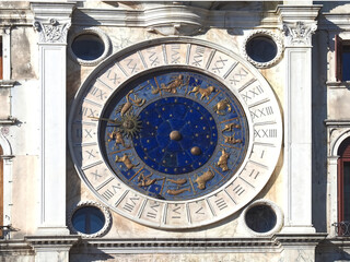 Sundial with zodiacal signs and a golden sun at St. Marks square in Venice