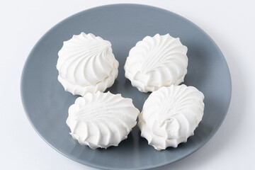 White zephyr on grey plate on white background.