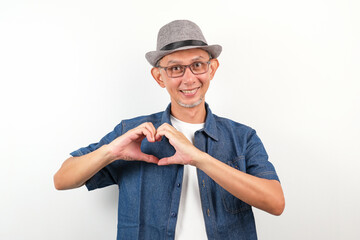 Happy Asian Man smiling with love sign or heart shape with hands on his chest, health concept
