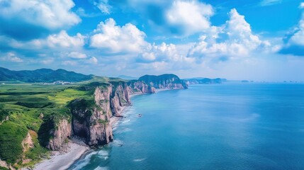 Fototapeta premium Panoramic view of a rocky coastline meeting the ocean under a cloudy sky landscape