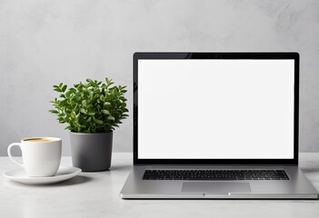 Laptops with blank white screens and coffee mugs on the desk