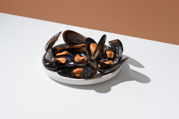 Plato de mejillones al vapor sobre fondo naranja	