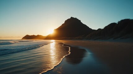 Fototapeta premium Golden Sunrise Over a Coastal Landscape With a Mountain and Rolling Waves