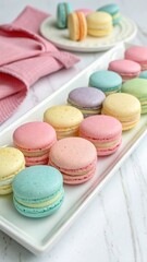 Pastel Macarons Arranged on a Rectangular Plate with Napkin on Marble Surface