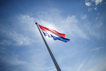 Waving Dutch flag against a vibrant sky in the Netherlands