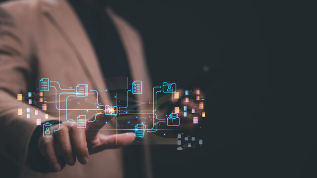 Professional gestures towards digital interface interconnected data networks, symbolizing integration of technology and information management in contemporary business environments