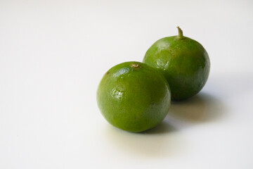 Two limes on a white background