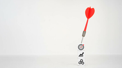 Target achievement with dart and icons.