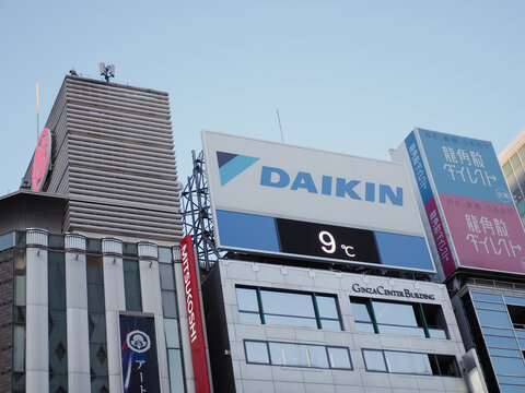 TOKYO, JAPAN - January 18, 2025: Daikin sign displaying the temperature on the top of a building in Ginza during winter. Next to it is Mitsukoshi Department store.