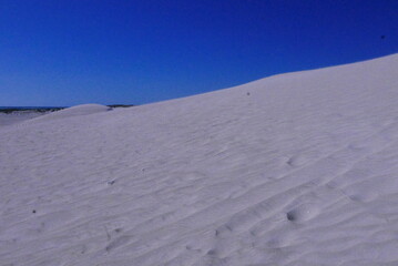 Lancelin, a coastal town in Western Australia, is famous for its white sand dunes, perfect for sandboarding, off-road adventures, pristine beaches, windsurfing, and a relaxed atmosphere.