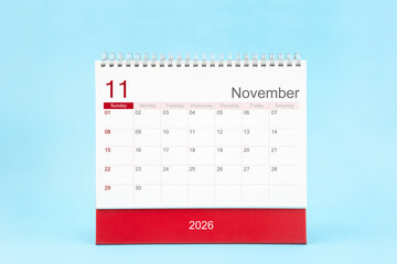 November 2026 Monthly desk calendar for 2026 year on blue color background, Front view.