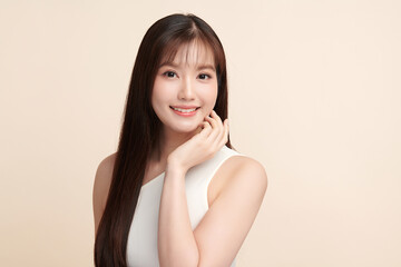 Fototapeta premium Beautiful young asian woman with clean fresh skin on beige background, Face care, Facial treatment, Cosmetology, beauty and spa, Asian women portrait.