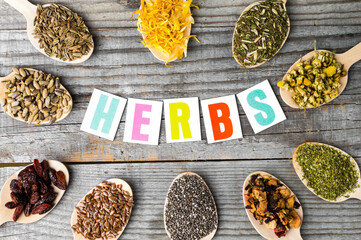Stomach sign. Herbal collection in wooden spoons: chamomile, calendula, dill and milk thistle seeds.Wooden Spoons with Dried Chamomile, Calendula, and Seeds on White Background. 
