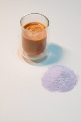 refreshing glass of Thai iced milk tea, served in a clear glass cup. The rich, vibrant orange color of the tea contrasts beautifully with the creamy milk at the bottom. A perfect blend